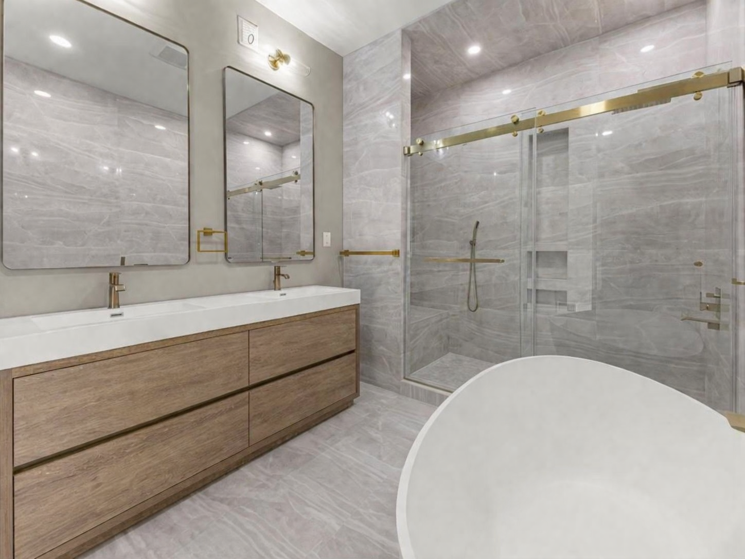 Spa-style bathroom renovation with tile and stone by Goldstein Construction