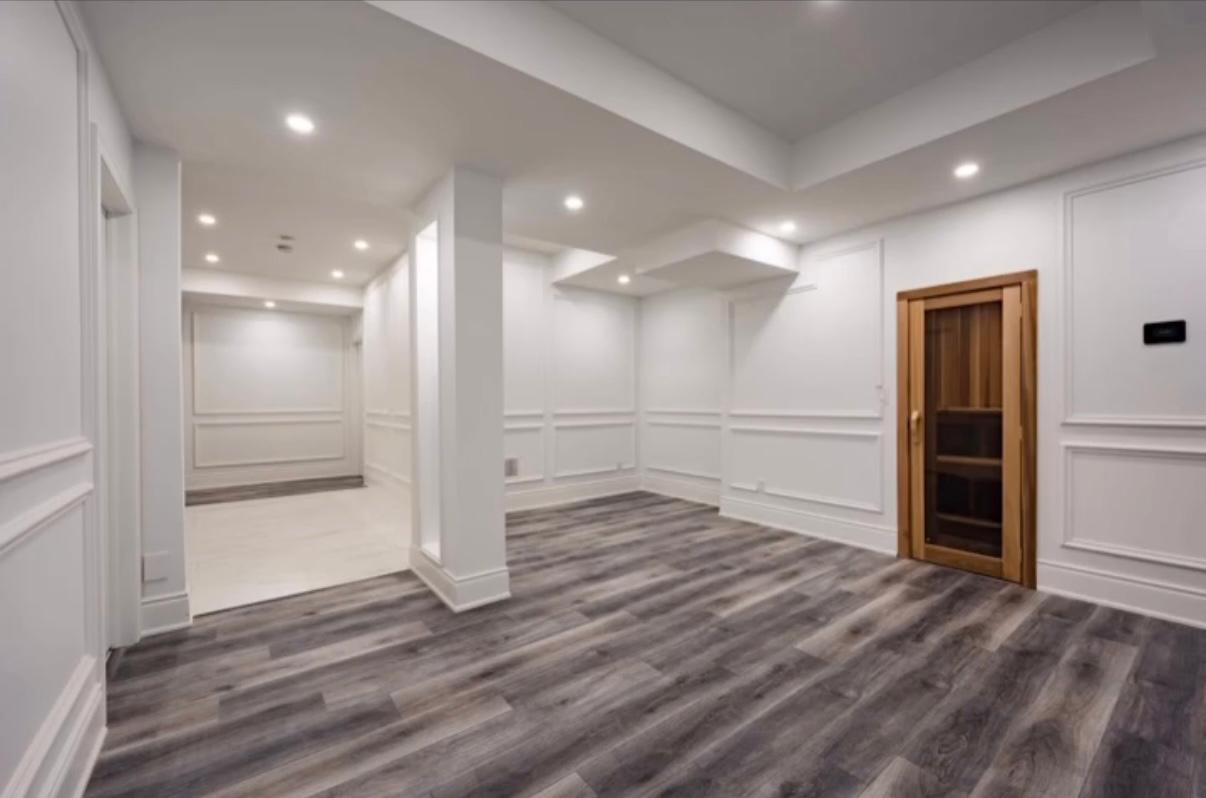 Finished basement with custom millwork and lighting by Goldstein Construction