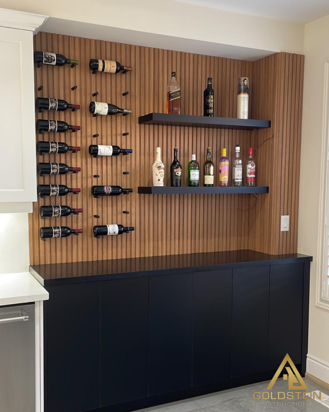 Walnut slat wine wall with floating shelves and matte black base cabinetry in a custom Richmond Hill kitchen renovation