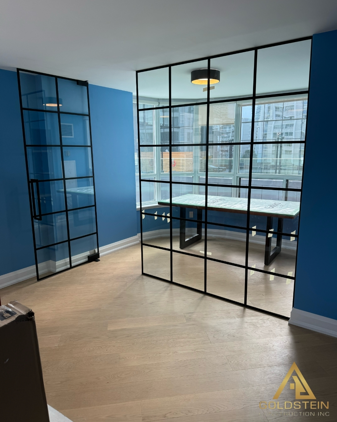Interior room with black steel and glass partition walls.